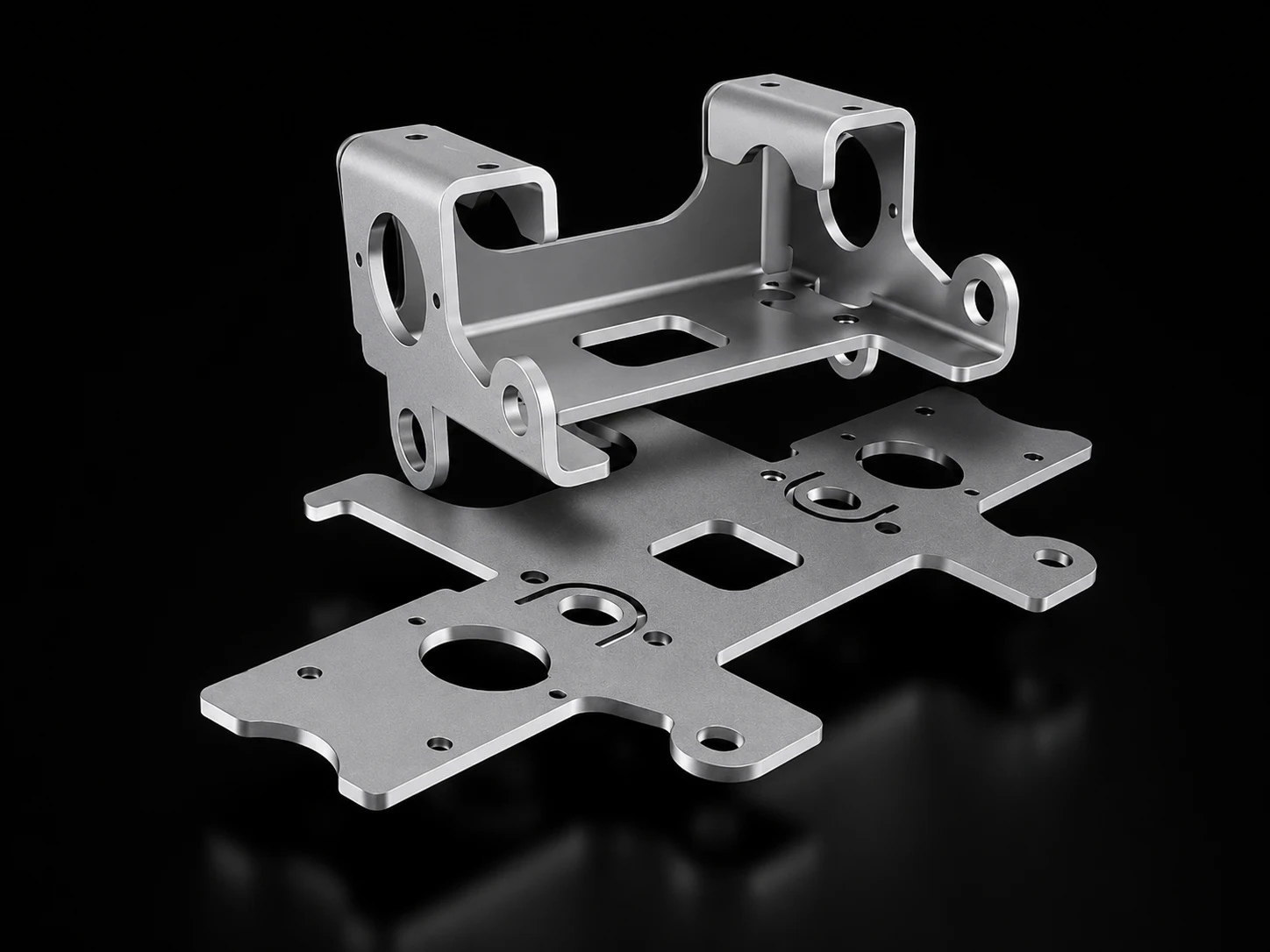 A flat laser-cut blank below and the same part formed into a machined bracket above